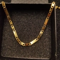 Golden stainless steel rectangle link necklace with engraved cross motifs in a black box - Necklace 2