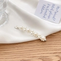 Minimalist silver bobby pin with various sizes of elegant pearls on silk background - Silver Staggered Pearl Bobby Pin