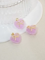 Drei lavendelfarbene Herzanhänger mit Zucker-Effekt und goldenen Schleifen für DIY-Schmuck - Violett