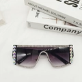 Close-up of black oversized sunglasses with gradient purple lenses and rhinestone detailing - Black Frame Dual Grey