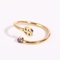 Macro view of gold Cancer zodiac ring with a purple gemstone and 69-shaped symbol - Cancer - Gold