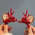 Pair of festive Christmas reindeer antler hair clips with red bows and berries - Knitted Antlers Red