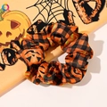 Detail of Halloween scrunchie with orange pumpkin faces and black checkered fabric pattern - Orange Pumpkin / Large Size