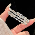 Detailed macro view of three stacked silver bracelets with sparkling cubic zirconia stones - 41# Silver Three-Piece Set Style