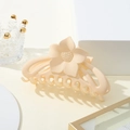 Detail of matte cream sunflower hair claw clip with floral texture and secure grip - Beige