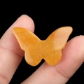 Polished yellow crystal butterfly carving decorative stone ornament held in hand - Yellow Jade
