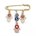Golden Hamsa hand brooch with three pendants and blue evil eye beads for women and men - Pin with Two Red Eye Hamsa and Long Chain Rhinestone Hamsa