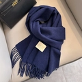 Deep blue 100% Australian wool scarf with fringe and brand label on grey background - Navy Blue