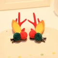 Pair of red reindeer antler hair clips with colorful plush balls on a white plate - Hair Clip 3# (Pair)