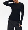 Detailed close-up of thumb hole cuffs on a slim fit black wool knit long sleeve top - S / Thumbhole Design / Black
