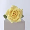 Handmade crochet bouquet featuring a yellow knitted rose with green leaves on white stand - Thai Rose Gradient Yellow
