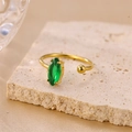 Vintage style gold open ring with marquise-cut green zircon on stone background - Green