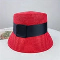 Detail of red woven straw sun hat featuring a black grosgrain ribbon and bow detail - M (56-58cm) Adjustable / Red
