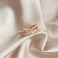 Elegant rose gold double-layer crisscross ring with zircons on beige silk fabric - Double Layer Crossover / Rose Gold