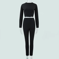 Detail of a black two-piece tight sports set with crew neck top and high-waisted pants - S / Black