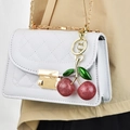 White quilted chain shoulder bag with a glittery dark red cherry charm accessory - Pink Cherry