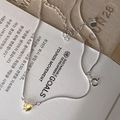 Macro detail of silver snake chain with a heart-shaped yellow gemstone pendant - Yellow Heart Style (MY34855)