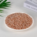 Bulk polished natural peach rose quartz crystal chips in a decorative white ceramic bowl - Sunstone (3-5mm) 100g