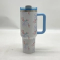 Detail of white 40oz stainless steel tumbler with blue handle and floral bow pattern - 40oz / White