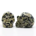 Dalmatian jasper hand-carved crystal skull figurines showing natural black spotted texture - Dalmatian Jasper
