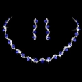 Close-up of bridal jewelry set with blue gemstones and silver rhinestones on black background - Necklace + Earrings / Royal Blue (2-Piece Set)
