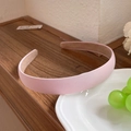 Minimalist pink fabric headband in a simple retro style shown on a wooden background - Deep Pink