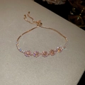 Macro detail of rose gold floral adjustable bracelet with pink zircon and slide clasp - 52# Gold Pave Flower Style