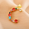 Macro shot of gold letter C pendant with vibrant colorful zircon gemstones detail - Letter C