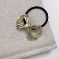 Elegant hollow metal bow hair tie in gold finish for high-end ponytail hairstyles - Gold