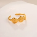 Macro detail of three gold shell motifs on a polished stainless steel adjustable ring - 18K Gold Three Shells