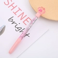 Pink liquid quicksand pen with a 3D cat paw topper and glitter filling on a notebook - Bear Paw Fairy Pen Pink