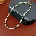 Close-up of pearl necklace with malachite and shell beads on leather jewelry box - Malachite Shell Bead Style / Gold-Green-White