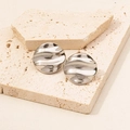 Detailed close-up of 304 stainless steel irregular wavy round stud earrings in silver - D217-S Silver Wavy Round