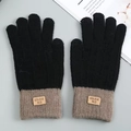 Detailed view of winter knitted touch screen gloves with warm fleece lining and brand tag - Black
