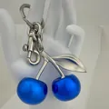 Glossy bright blue cherry keychain with silver metal hardware on a white background - Agate Blue Cherry with Matte Silver