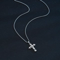 Silver stainless steel cross necklace with stones on a blue textured background - 3-layer Cross