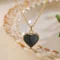 Elegant gold-tone chain necklace with a minimalist black enamel heart pendant for women - Black