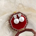 Detail view of pearl stud earrings with sparkling zircon on a red velvet jewelry box - 925 Sterling Silver Pin Studs / Silver