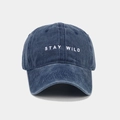 Dettaglio del ricamo 'STAY WILD' su un cappello in cotone blu scuro lavato - Blu navy