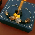 Close-up of golden round hoop earrings with grey and yellow irregular agate beads - Ear Buckle-Gold-Grey-Black Agate (WE4606)