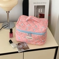 Pink checkered quilted makeup bag with blue bows and convenient carrying handle - Makeup Bag / Red