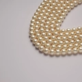 Strand of high-quality round cream white shell pearls with a smooth glossy finish - Beige 10mm/40cm