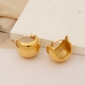 Chunky gold irregular stainless steel hoop earrings on beige silk fabric background - Curved Ear Cuff Hoop Earrings / Gold