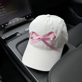 Detailed close-up of a white cotton baseball cap featuring a large pink satin bow decoration - M (56-58cm) / White - Pink Bow