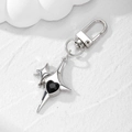 Detailed macro view of silver star keychain featuring a faceted black heart gemstone - Black Rhinestone Heart