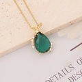 Detail of gold necklace with green teardrop stone, bee charm and zircon accents - Green