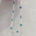 Detail of white seed bead necklace with blue starfish pendants and silver extension chain - Off-white Beads + Blue Starfish Necklace