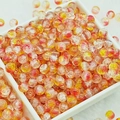 Close-up of yellow and red gradient crackle glass beads for DIY jewelry making - 6mm / Orange Red