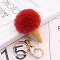 Detail of red fluffy pom pom ice cream keychain with golden metal clasp and chain - Burgundy