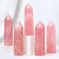Set of five natural rose quartz hexagonal crystal pillars on white display pedestals - 9-10cm